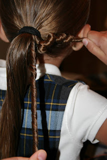 Young girl's hair being styled in to "Ponytail Of Twists" hairstyle