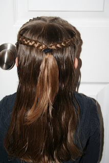 Back view of a young girl modeling “French Designer Heart” hairstyle