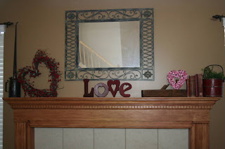 Valentine's Day themed decor around the fireplace mantle 