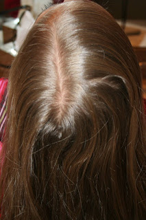 Top view of young girl's hair being styled into "Beachy Combo" hairstyle