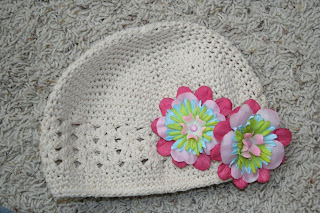 Product photo of cream beanie hat and two multi-color flower clips