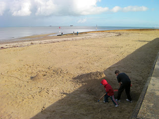 excavating sand. digging a hole in the beach