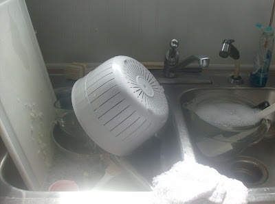 Sink full of dirty dishes that were used to prep meals.