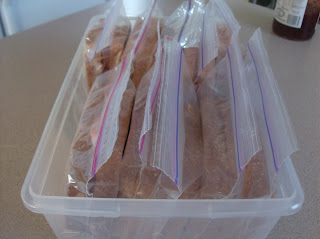 Sandwiches lined up in a clear plastic container.