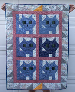 six blue kittens with gray mice around the kitten blocks and two chunks of cheese