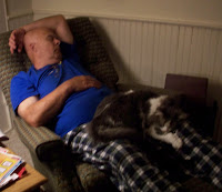 Dad sleeping in chair with Annie on his lap