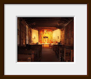 A filtered and soft warm glow lights the altar inside this ornately decorated Spanish mission in New Mexico.