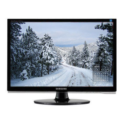 a computer monitor showing a mountain road covered with snow and lined by pines makes a great wallpaper calendar