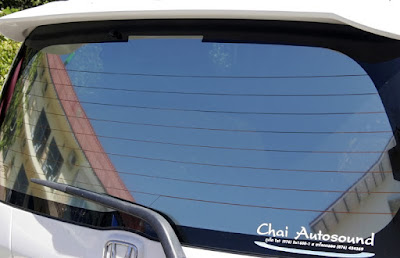 Blue Skies reflected in rear window of Honda Jazz