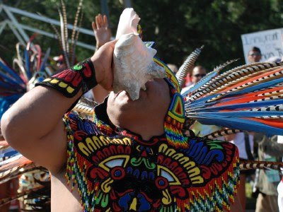 Aztec dancer with conch shell, Immigrant Rights March