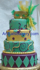 Four tier Mardi Gras birthday cake with feather mask topper