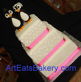Three tier square fondant wedding cake with pink ribbons