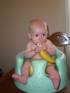 Baby eating solid banana
