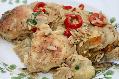 plate with chicken, artichokes, and orzo