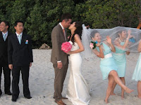 the bridal couple kissing by the beach