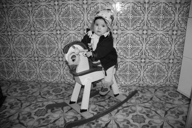 Criança no cavalo de madeira