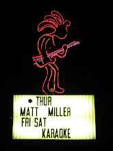 sign in front of frankie d's by night