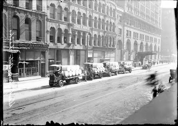 4 Chicago Daily News paper trucks parked along the curb of W. Madison St. Chicago 1912