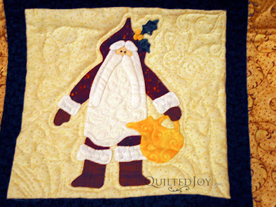 Eve's Santa Applique Quilt with custom quilting by Angela Huffman - QuiltedJoy.com