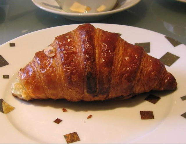 Single croissant on a plate