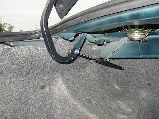 …the strut bolts on to the boot arm using the existing torsion bar hole. For this you need to drill through the back of the empty mounting at the one end of the strut and a couple of decent length bolts…