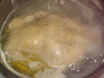 Cook whole chicken in water.