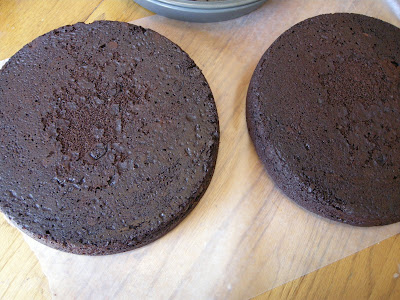 Chocolate velvet cakes cooling on countertop.