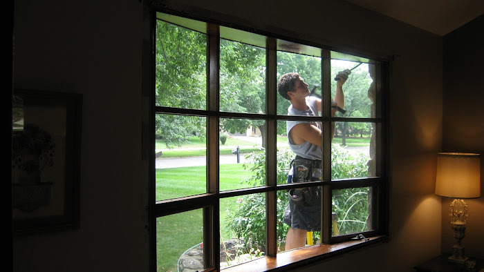 "Before" interior photo of an older single-pane bow window