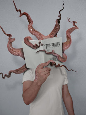 child holding up book entitled the power of books, with tentacles coming out of it.