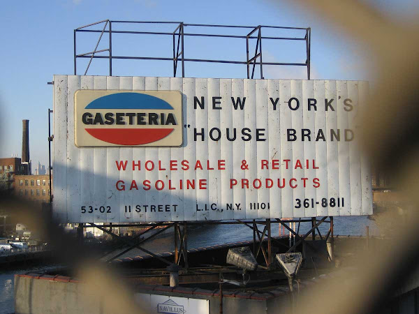 New York's House Brand - Next to the Pulaski Bridge in Long Island City, Queens, the sign's now covered with a cheap banner ad.