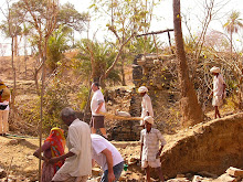 INDIA: Volunteer carrying bags of dry cement