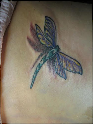 Colorful dragonfly tattoo design on the back.