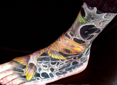 Female Tattoo With Japanese Koi Fish Tattoo Design On The Foot