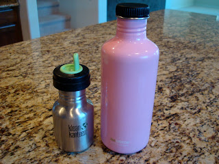 Two re-useable water bottles on countertop  - 23