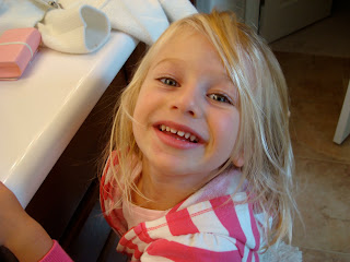 Young girl leaning toward countertop smiling