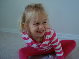 Young girl sitting in room smiling