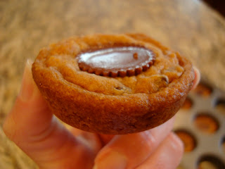 Hand holding one Peanut Butter Cup Chocolate Chip Cookie