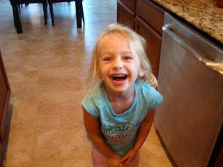 Young girl smiling in kitchen