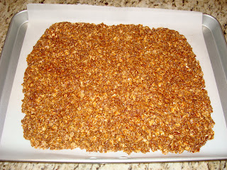 Vegan GF Granola spread out on parchment lined pan