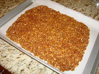 Granola spread onto parchment lined sheet