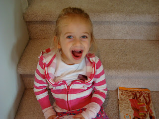 Young girl sitting on steps making silly face