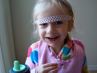 Close up of young girl with headband above eyes smiling