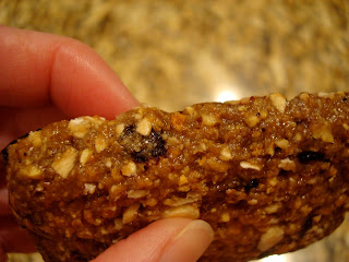 Hand showing side of clif bar and blueberries