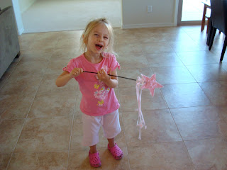 Young girl dancing with princess wand