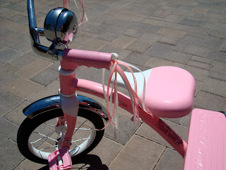 Close up of tassels on pink tricycle