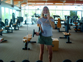 Woman in mirror holding dumbbell