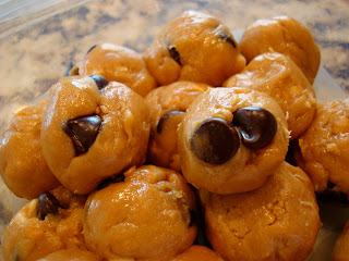 Stacked No-Bake Vegan Peanut Butter Chocolate Chip Cookie Dough Balls in container