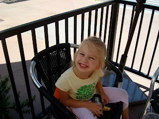 Young girl sitting on chair smiling