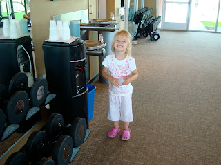 Young girl standing next to water cooler smiling