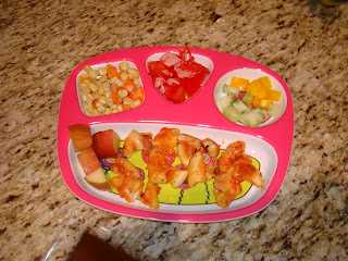 Child's plate with a mixture of fruit, vegetables and sliced up pizza  - 11